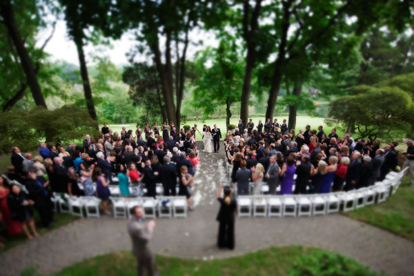 One of the things I'll do is set up a remote camera in the back of the ceremony, elevated if possible.  In this shot, a tilt-shift lens was used to create that miniature look.  EOS 5D Mark III, TS-E 17mm f/4L. Exposure was 1/320, ISO 3200, f/4. 