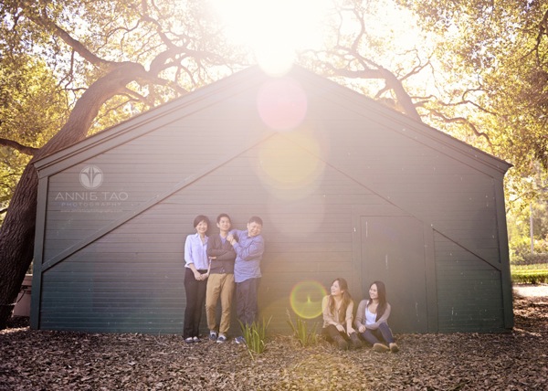 Annie Tao Photography San Francisco Bay Area family photography family against a barn with trees and sunflare