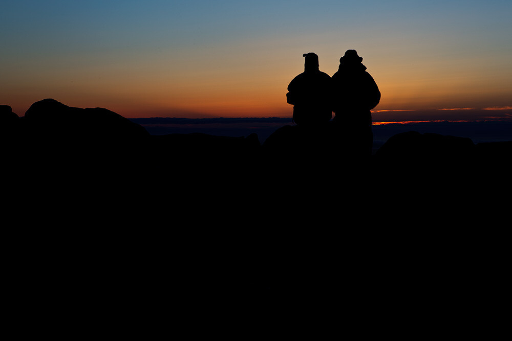 I was shooting the sunrise on Cadillac Mountain in Acadia National Park when I spied this couple sitting on a rock. I moved around behind them, and spot-metered on the sky. Because the meter tries to make the metered area a mid-tone, I knew it would silhouette my subjects perfectly.