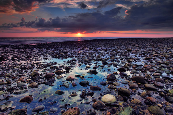 For this image, I used a 4-stop hard edged ND grad, to bring the sky back within the dynamic range of the camera. I used the hard edge here because there was nothing intersecting the horizon from the foreground, which made it very easy to line up the darkened edge with the horizon out on the bay. Exposure was 1.3 seconds, ISO 100, f/16. EOS 5D Mark II with EF 17-40 f/4L.