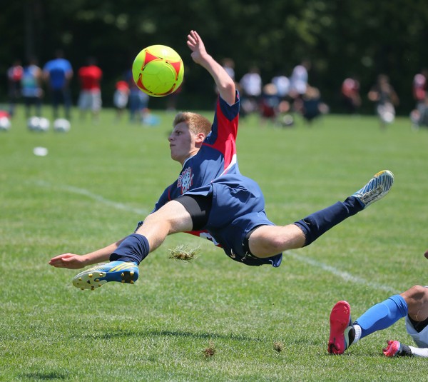 This shot was part of a sequence that started with this player making a run with the ball. A few frames prior to this, he was tripped and went airborne along with the ball. I never would have had this frame if I wasn't shooting at 12 fps. Canon EOS-1D X, EF 200-400 f/4L IS Extender 1.4x. 1/1600, f/5.6, ISO 800.