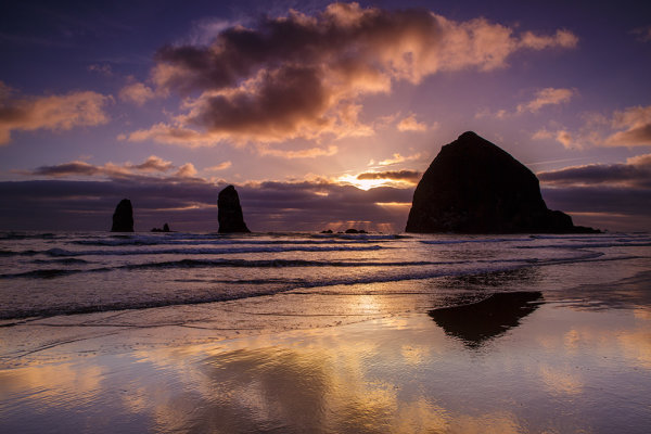 Haystack Rock dominates the landscape at Cannon Beach. The wet sand, dramatic skies, and great light combined for some great images. Canon EOS 5D Mark III, EF 24-70 f/2.8L II at 24mm.  1/40 second at f/16, ISO 200.  I used a 4 stop graduated neutral density filter on the sky. 