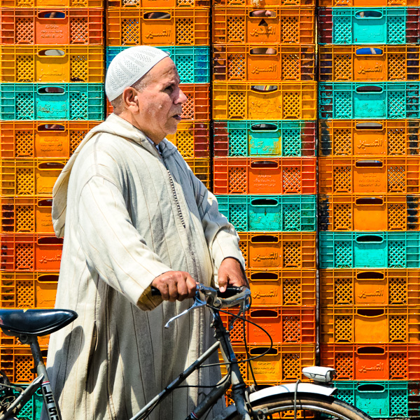 Essaouira, Morocco. I waited many minutes in front of this colored plastic boxes wall and took the same picture with other men, women, couples and kids. In the end, the guy in a white dress with a bicycle seemed like the best choice. 