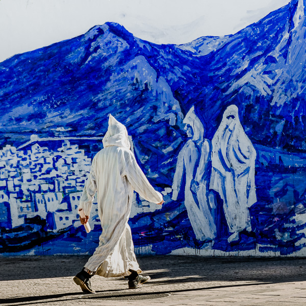 Chefchaouen, Morocco. I wanted to portray someone wearing the same outfit as the people in the painting, so I waited until the perfect subject passed by.