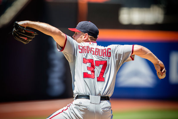 Shooting the pitcher from behind can give this kind of a dramatic shot. Using the continuous drive setting to shoot many frames throughout the motion will help you ensure that you get the best part of the motion.