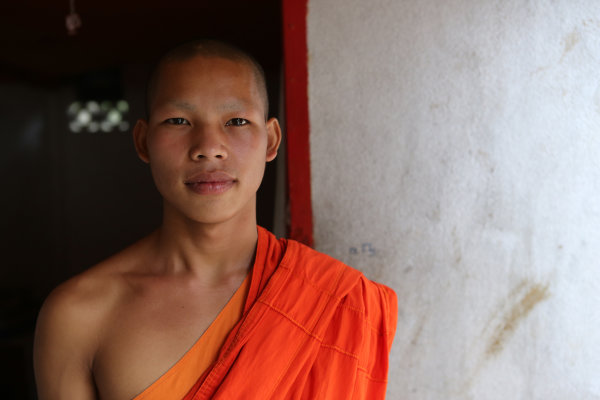 -Laos- Canon EF 24-70 mm f/2.8L Fstop of 3.5, shutter speed@1\1600 and ISO 1000 I used the soft light coming through a red robe which was on the right side of the frame, in order to 