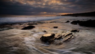 As the sun was setting on Pelican Point in Laguna, the tide rushed around this set of rocks. EOS 5D Mark III with EF 24-70 f/2.8L II. .8 seconds, f/11, ISO 400.