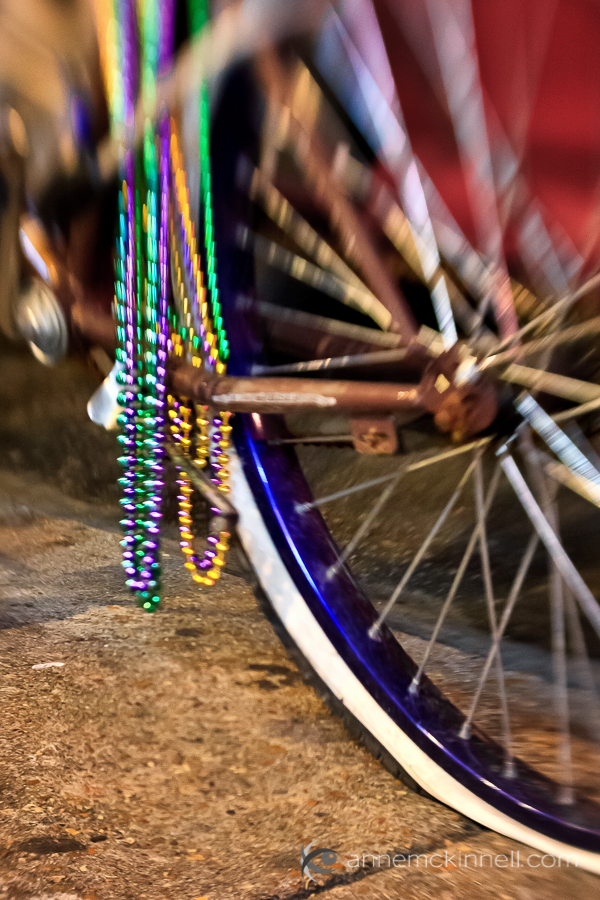 photography rut and motivation Bicycle with flat tire and Mardi Gras beads in New Orleans, by Anne McKinnell.