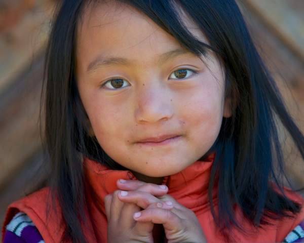 Travel Photography Tips - People - Little Girl with Hands Folded at Pepper House  Bumthang Valley Bhutan  Copyright 2013 Ralph Velasco