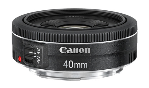 The Canon 40mm f2.8 pancake is about as small and light as you can get. Pancake lenses are the ultimate in unobtrusive lenses.
