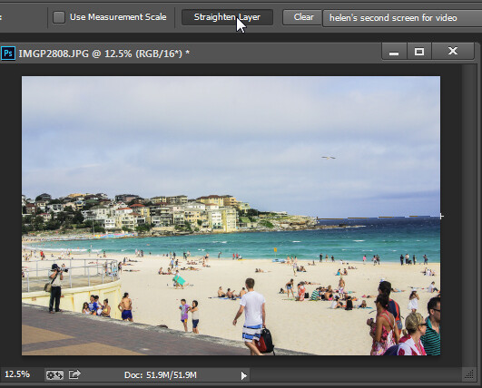 Click Straighten Layer in Photoshop CS5 and later to straighten using the Ruler tool.