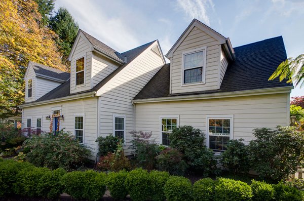  This home has a huge yard and a street lined with cars. Photographing from the left put the sun right above the roof but moving to the right side was a better perspective and the sun was out of view.