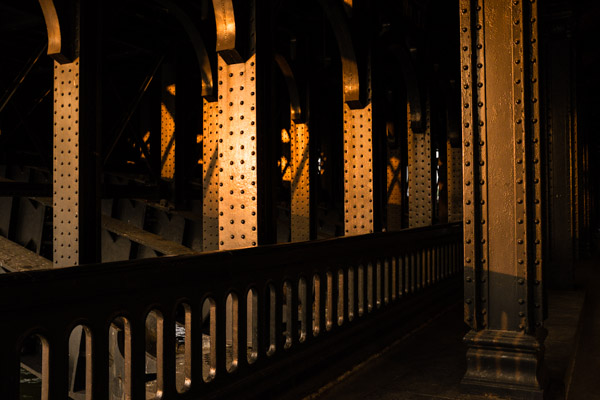 Look behind you! Everyone was looking at the sun setting over the river Seine in Paris, I looked back and was struck by the beautiful golden light hitting the bridge posts.  ©Valerie Jardin