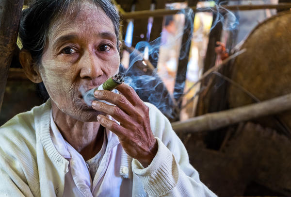 Old Burmese woman smoking a cigar