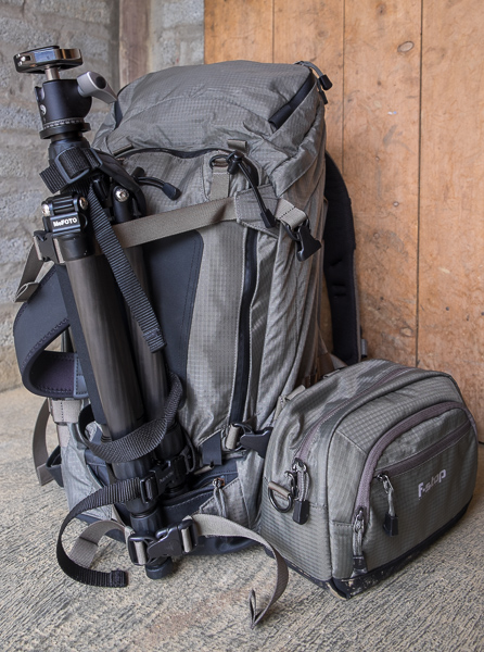 F-Stop Tilopa BC bag with tripod attached at the front and accessory attached to the side via the MOLLE system