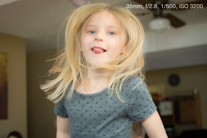 The only way to get a non-blurry picture of this girl jumping on her trampoline was to use both a wide aperture and fast shutter.