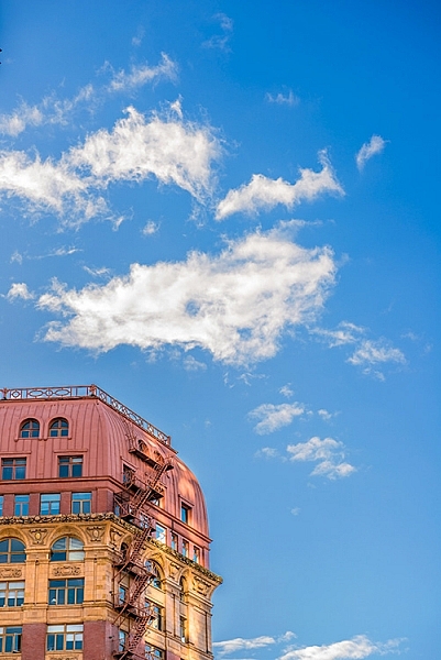 By cropping the building quite aggressively, the image seems unfinished, but the colours and the sky make it work