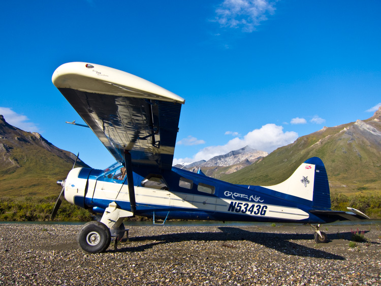 A DeHaviland Beaver, classic Alaska bush plane on a riverside gravel bar in the Brooks Range of northern Alaska.