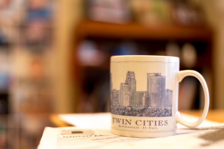 To put my money where my mouth is, I took my camera to work and literally snapped a picture of a coffee cup on my desk. No photoshopping or magic tricks here, just a wide f/1.8 aperture. 50mm, 1/100 second, ISO 160