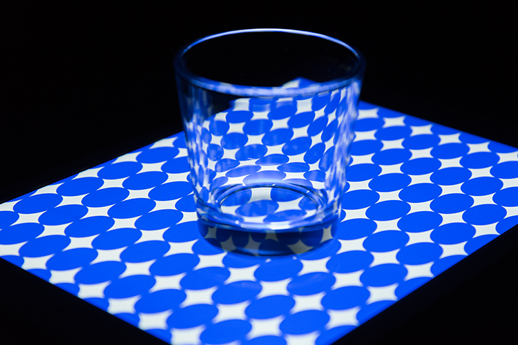glass-tumbler-on-blue-circles-background