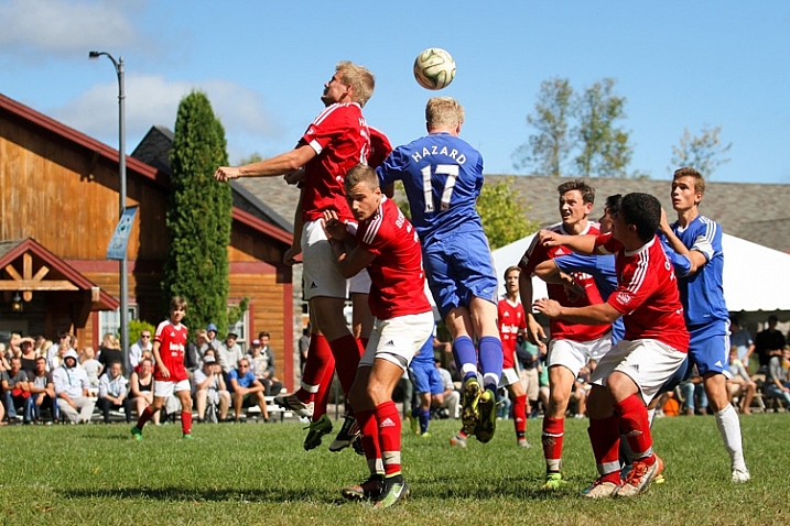 Soccer players attempting to head the ball into the net from a corner kick