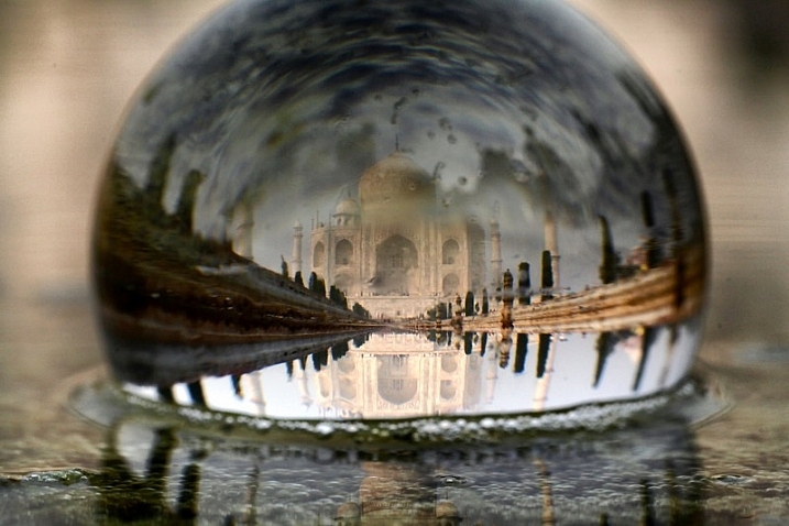 In this photo of the Taj Mahal there is reflection in the background, and this reflected image is in fact upside down.
