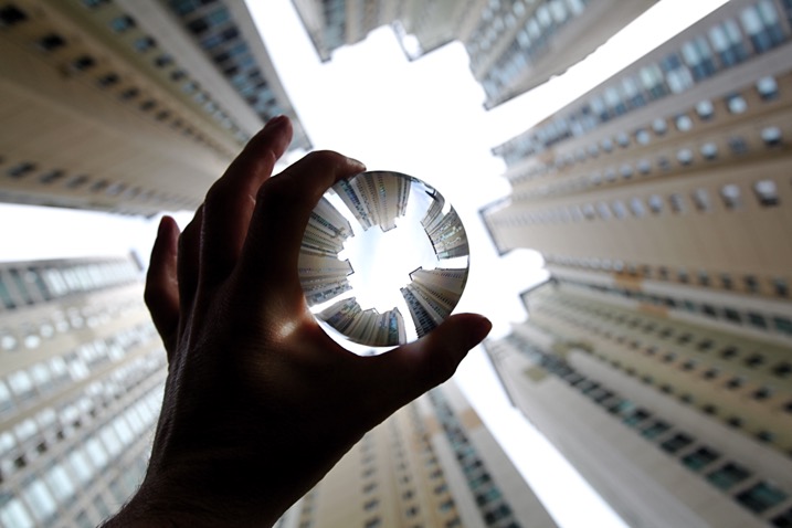 Apartment buildings in Busan, South Korea. This photo shows a glass ball being held by hand.