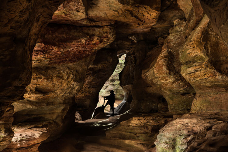 In this image of Rock House in Hocking Hills State Park in Logan Ohio adding the Silhouetted figure at the end of the cave adds a sense of scale and also adds a focal point to the image. 