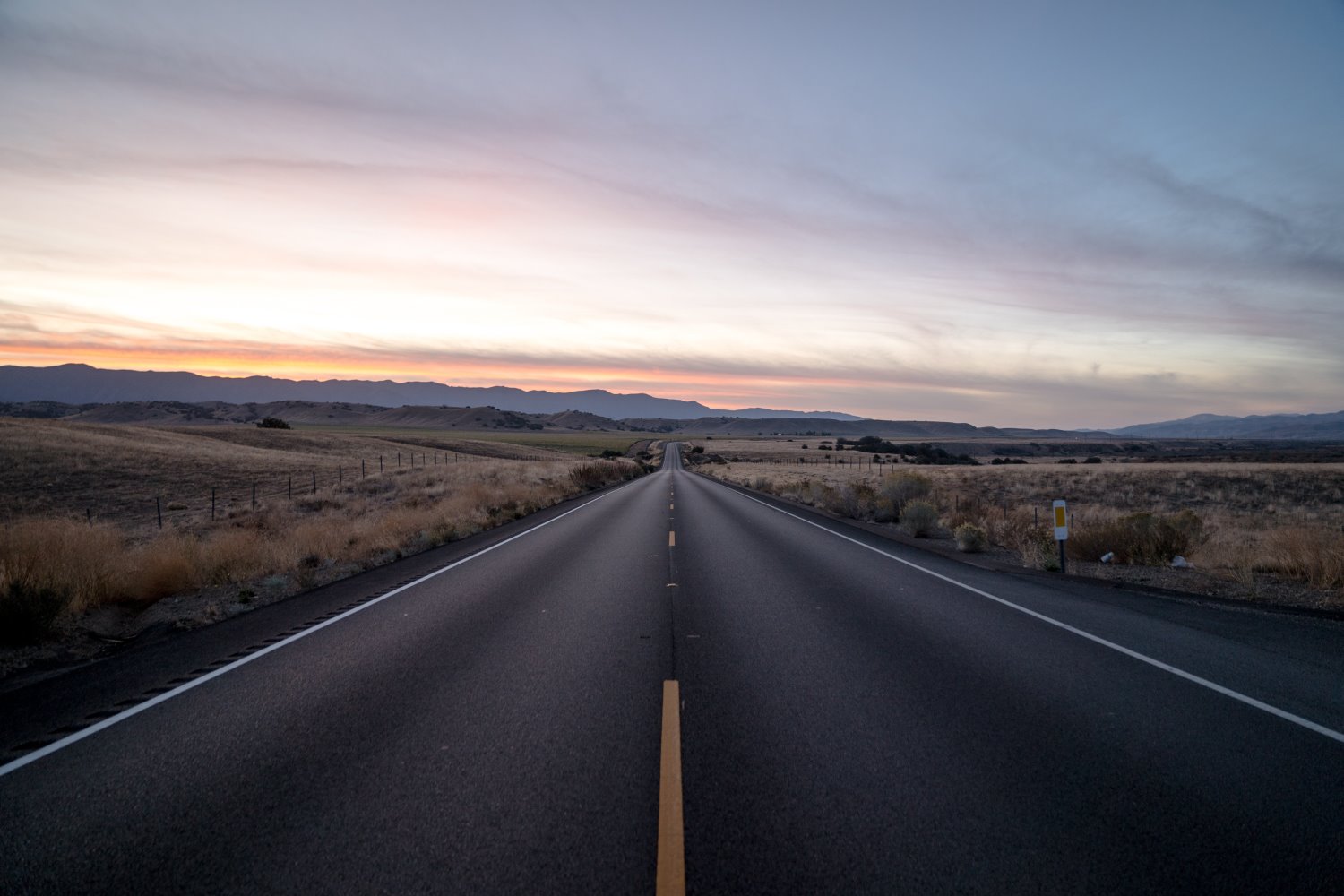 Using a Traffic Mirror as a Fisheye Lens for a Selfie on a Mountain Road  Stock Photo